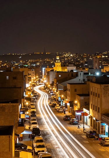 A long exposure photography shot of city lights in a North African / Moroccan metropolis at night, creating gold and white light trails.
