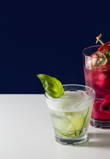 Product photography - two cocktails in glasses with strawberries and limes