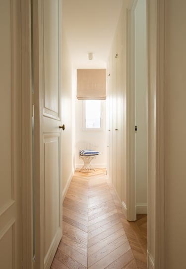 Couloir avec rangements sur mesure et parquet point de Hongrie dans un appartement à Paris