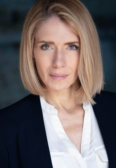 a woman with blonde hair and a white shirt