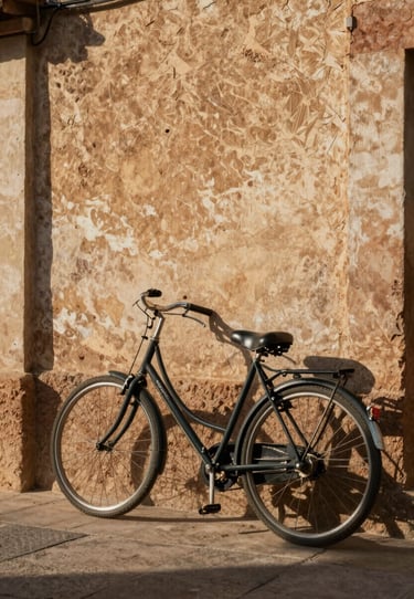 A classic bicycle leaning against a textured, sun-warmed plaster wall in a Spanish village, cinematic shadows and warm earthy tones.