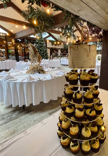 a wedding cake with cupcakes and cupcakes on a table