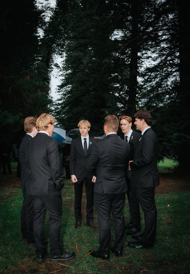 Groomsmen gathering beneath the pine trees before the ceremony at Adelaide Botanic Garden