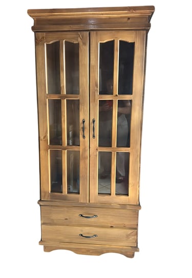 a cabinet with a glass door and a drawer