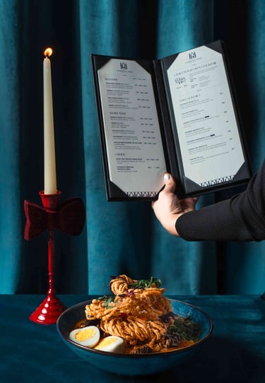 Professional food photography for a Toronto restaurant featuring an aesthetic menu and noodle dish.