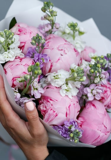 a girl holding a bouquet of flowers in the hands