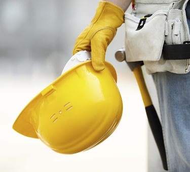 a person wearing a yellow helmet and gloves