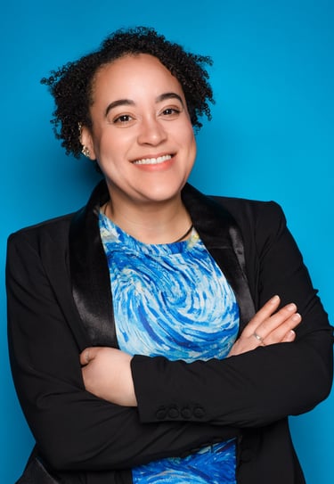 a woman in a blue dress shirt and black jacket