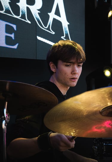 a man playing drums in a band