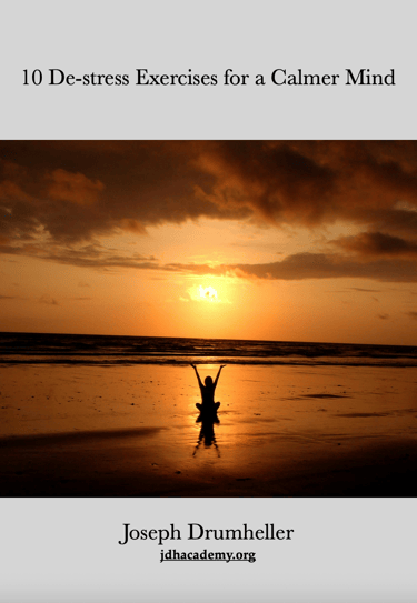 a person standing on a beach with a sunset in the background