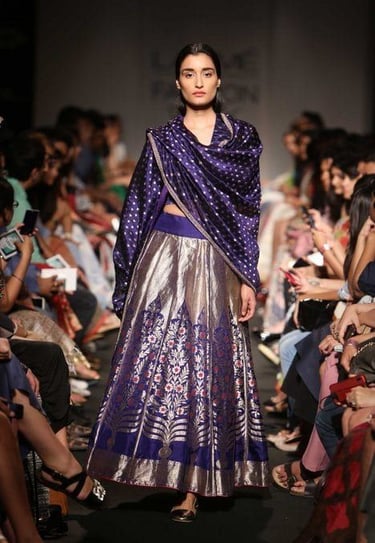 A model doing a ramp walk in a dress made from handloom fabric
