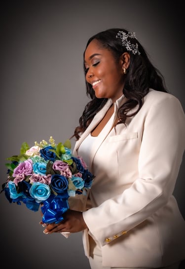 a woman in a white suit and a bouquet of flowers