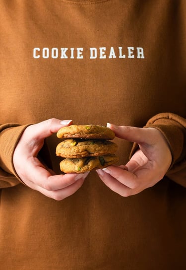 a person holding a stack of cookies in their hands