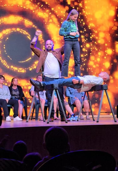 a man standing on a stage with a woman on stage