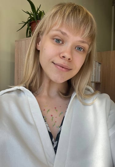 a woman with blonde hair and a white shirt