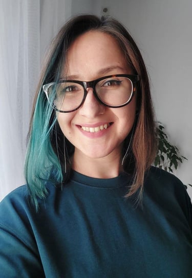 a woman with blue hair and glasses on her face