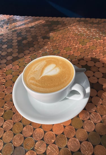 oat flat white with heart latte art served at the ark northampton vegan cafe