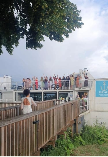 women are welcoming a guest on board the ark northampton as she arrives to her hen party