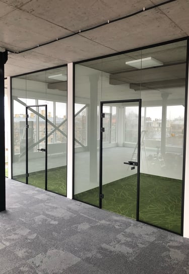 a large glass door with a green carpet