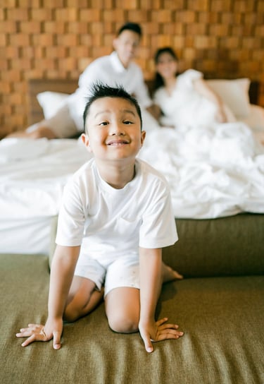Child smiling during a playful family photography session at Anantara Uluwatu Bali.