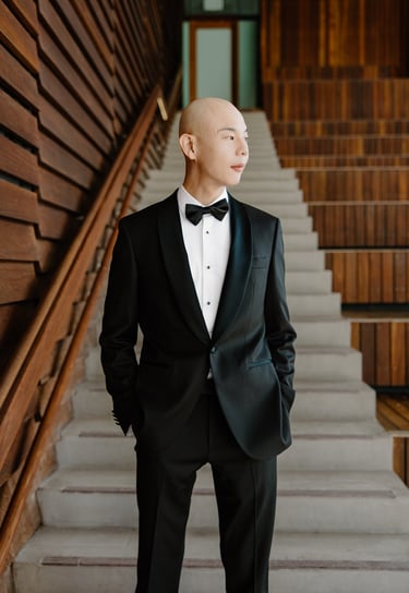 a man in a tuxedo suit and bow tie on his wedding day