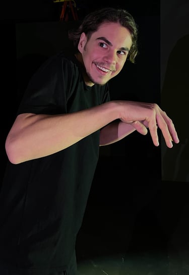 a man in a black shirt is holding a skateboard