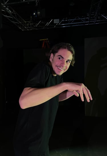 a man in a black shirt is holding a skateboard