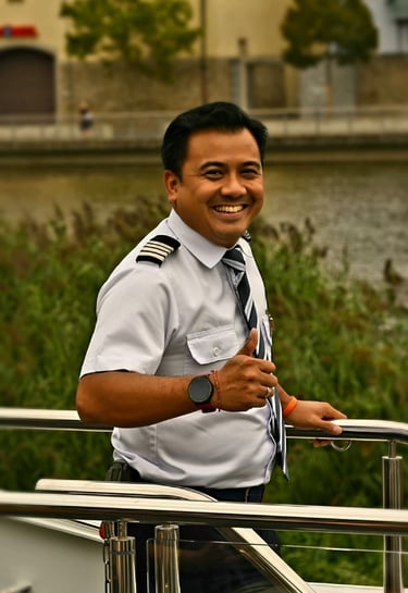 the first Asian Hotel Manager in European river cruise in uniform smiling on deck