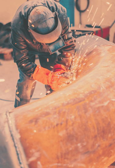man welding gas pipeline