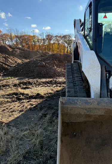skid-steer-with-dirt-pile