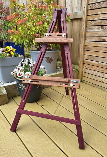 an artists easel on decking in a garden