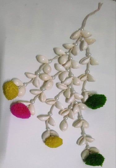 "Handmade shell hair tassel with colorful artificial flower ends–tribal-inspired accessory-Designed for export"