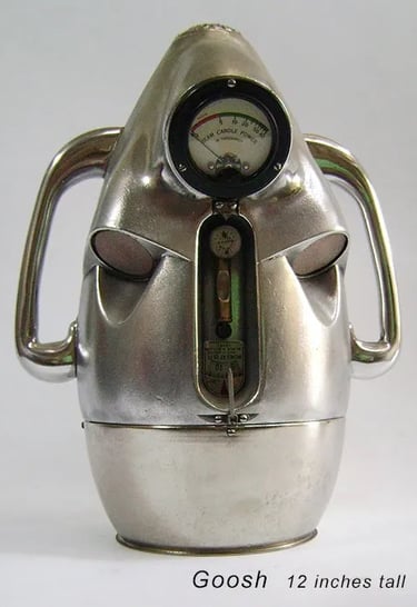 Found object robot head built by artist Tal Avitzur from vintage headlamp tester.