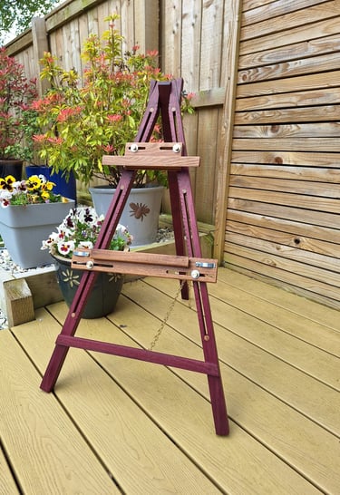 an artists easel on decking in a garden