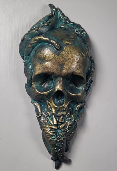Bronze Cthulhu plaque. A skull with tentacles growing out of it. Teeth grow out of the tentacles to form the bottom jaw.