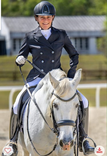 Renee Waters on a grey dressage horse in competition attire