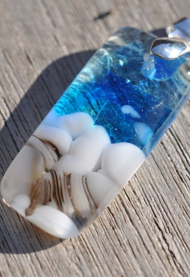 a blue and white glass pendant