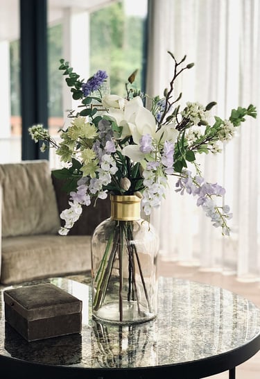 a vase with flowers on a table