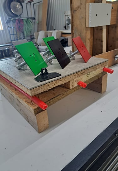 Mounted color-coded anchor plates displayed on a construction test setup for framing and insulation systems