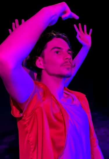 a man in a red shirt and a red capelet