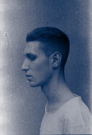 a man with a short haircut and a white shirt in a analogue 35mm photo