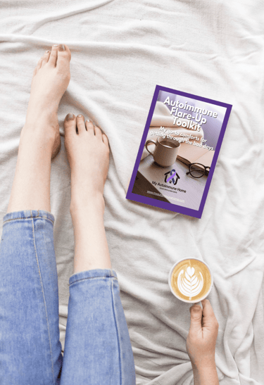 woman in bed drinking coffee, book at her feet
