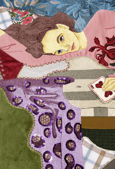 Embroidery details of a woman laying on a couch with a blanket