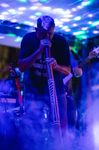 man playing a didgeridoo
