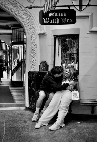 Young couple on a city bench having a laugh