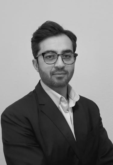 a man in a suit and glasses posing for a picture