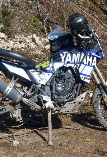 a motorcycle parked on a dirt road