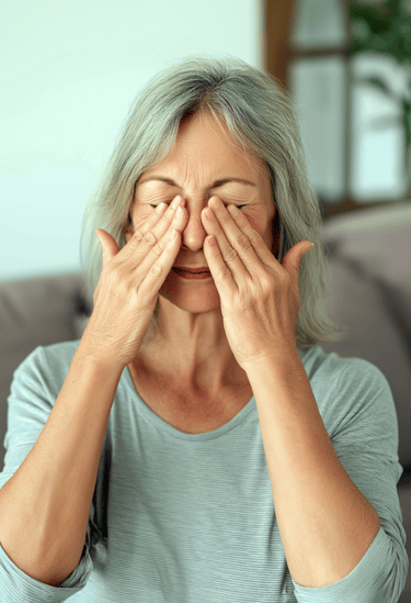 Adult with myopia rubbing her eyes
