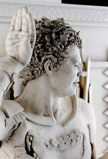 Detail of ceramic sculpture head and hand of fragmented dancing satyr.