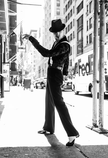 A man in a cool costume with a hat posing in NYC